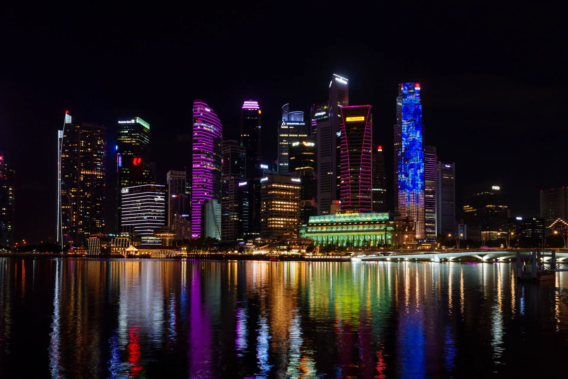 Singapore skyline at night reflected in Marina Bay